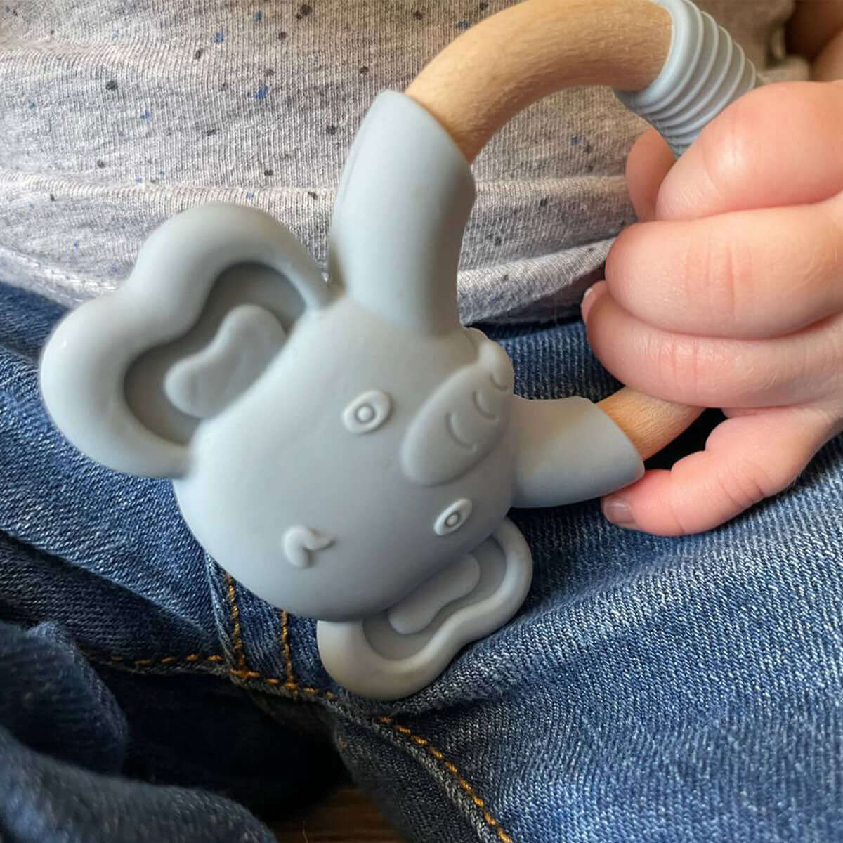 Baby holding MomMed Silicone Baby Teether elephant toy