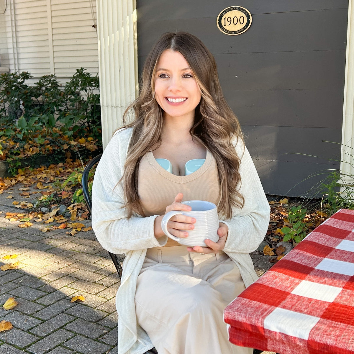 A mother using the S10 Pro Double Wearable Breast Pump to express breast milk