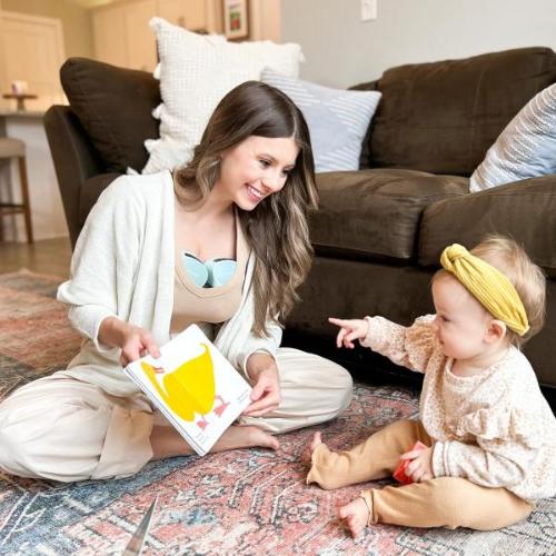 A mother plays with her baby while pumping milk using the S10 Pro Double Wearable Breast Pump