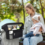 A mother uses MomMed universal stroller organizer to store things when taking her baby out for fun